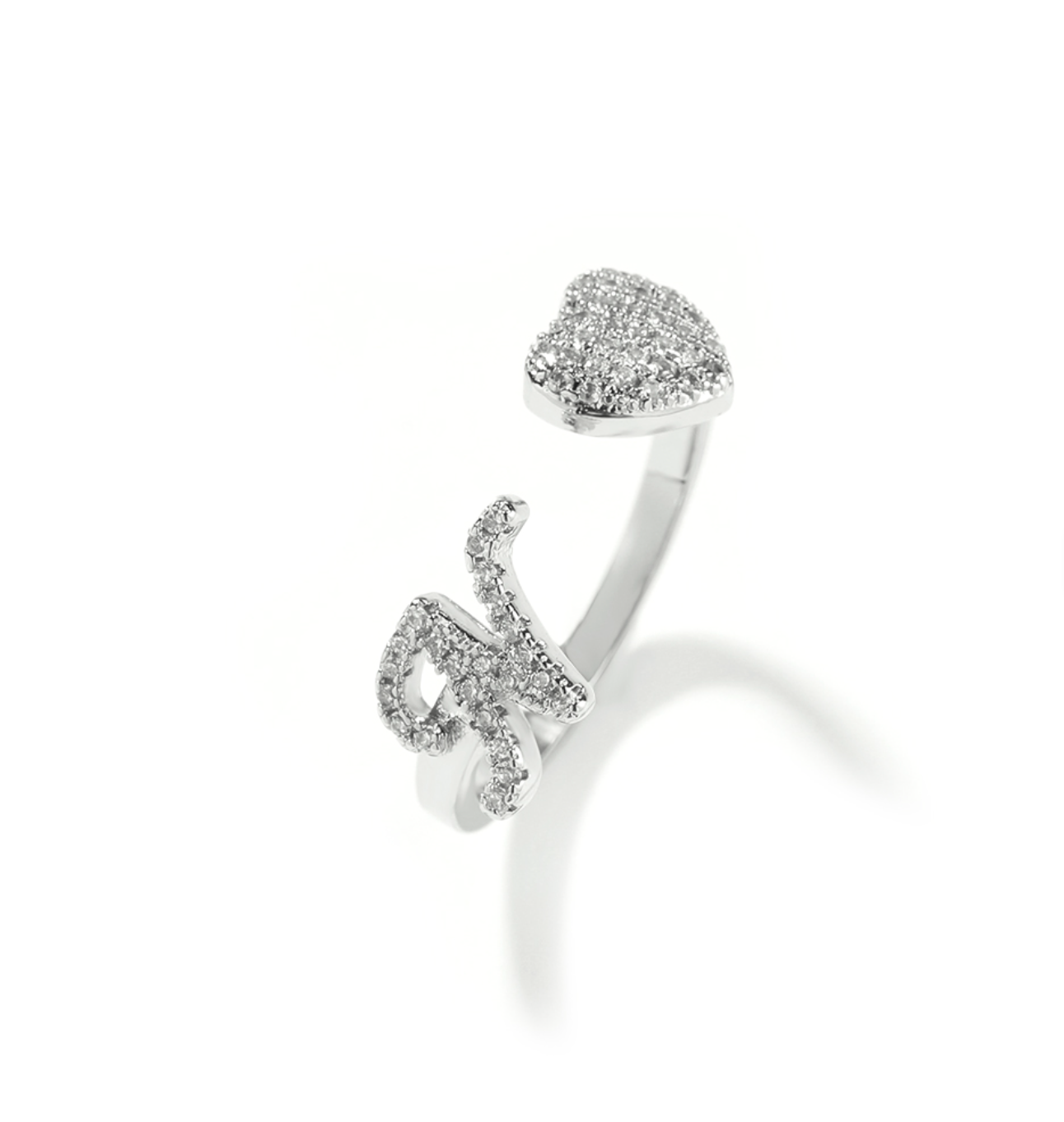 Silver open ring with heart-shaped top and curved design on a white background