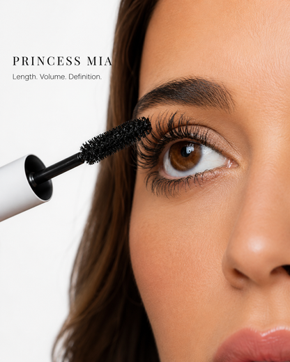 Person applying mascara labeled 'Princess Mia' to their eyelashes.